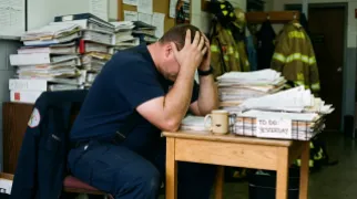 Firefighter Buried Under Mountain of Paperwork Declared "Still Alive, Probably"
