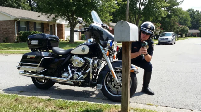 Officer Spotted "Hiding" Behind Mailbox Half His Size